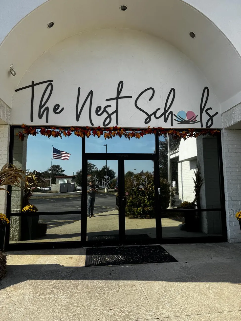 Glass storefront entrance of The Nest Schools with commercial solar window film in Northeast Ohio