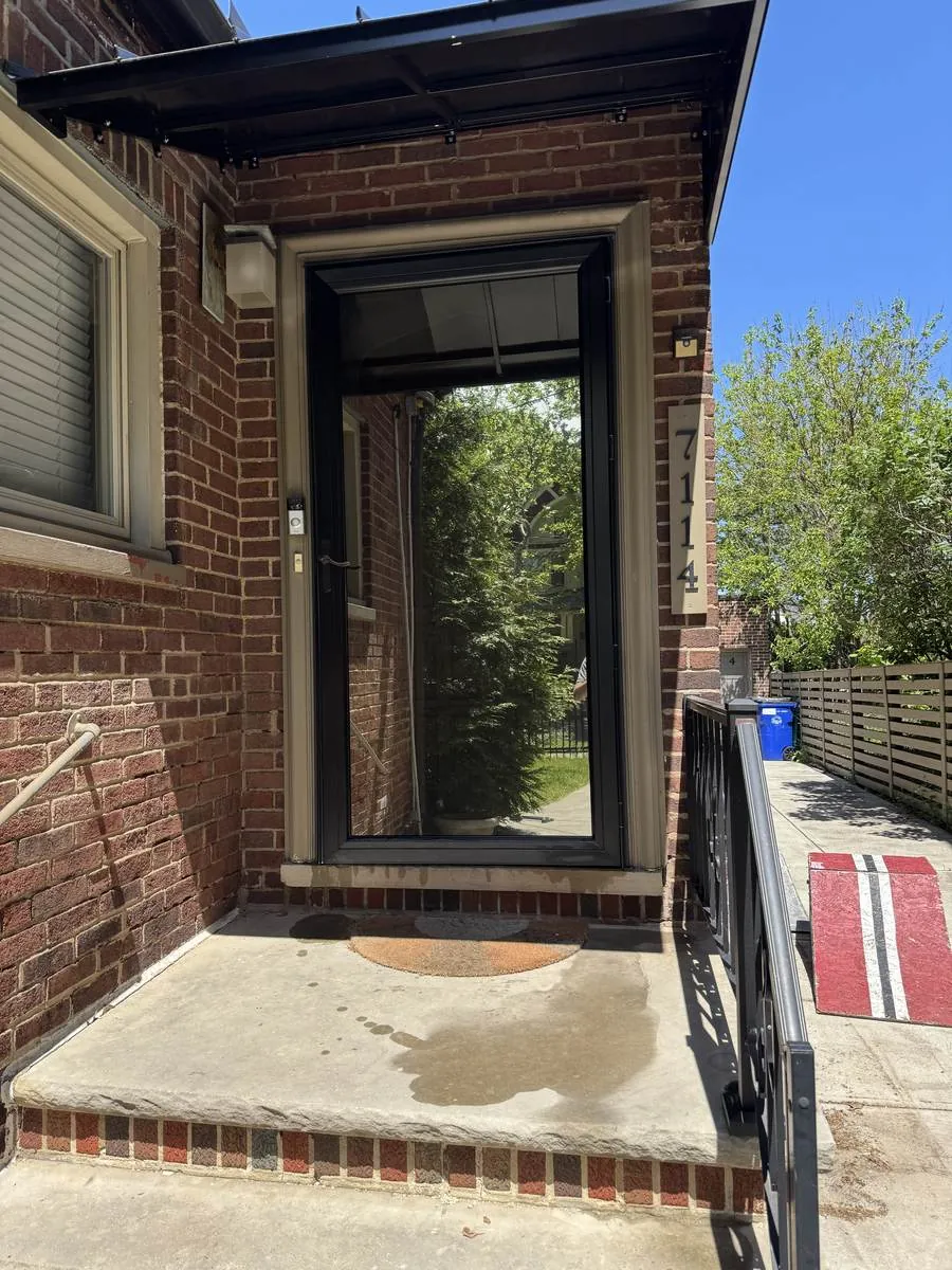 Brick home glass entry door with new window film in Northeast Ohio