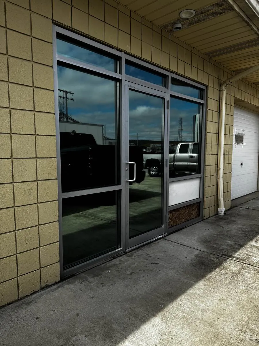Commercial storefront glass door and windows with dark solar film